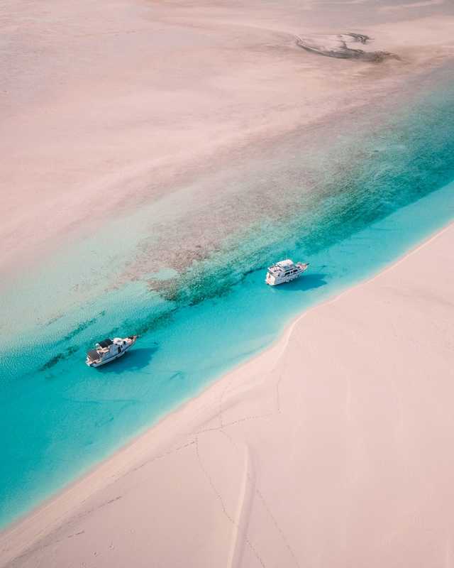 Pale sandbars wind through turquoise water, seen from above.